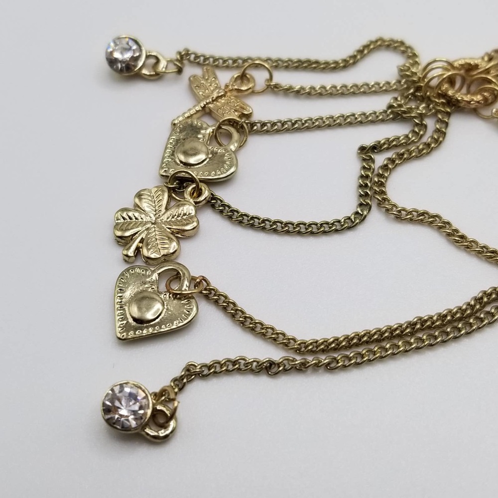 Gold Tone Lariat Necklace with Dangling Charms Hearts, Dragonfly & 4 Leaf Clover